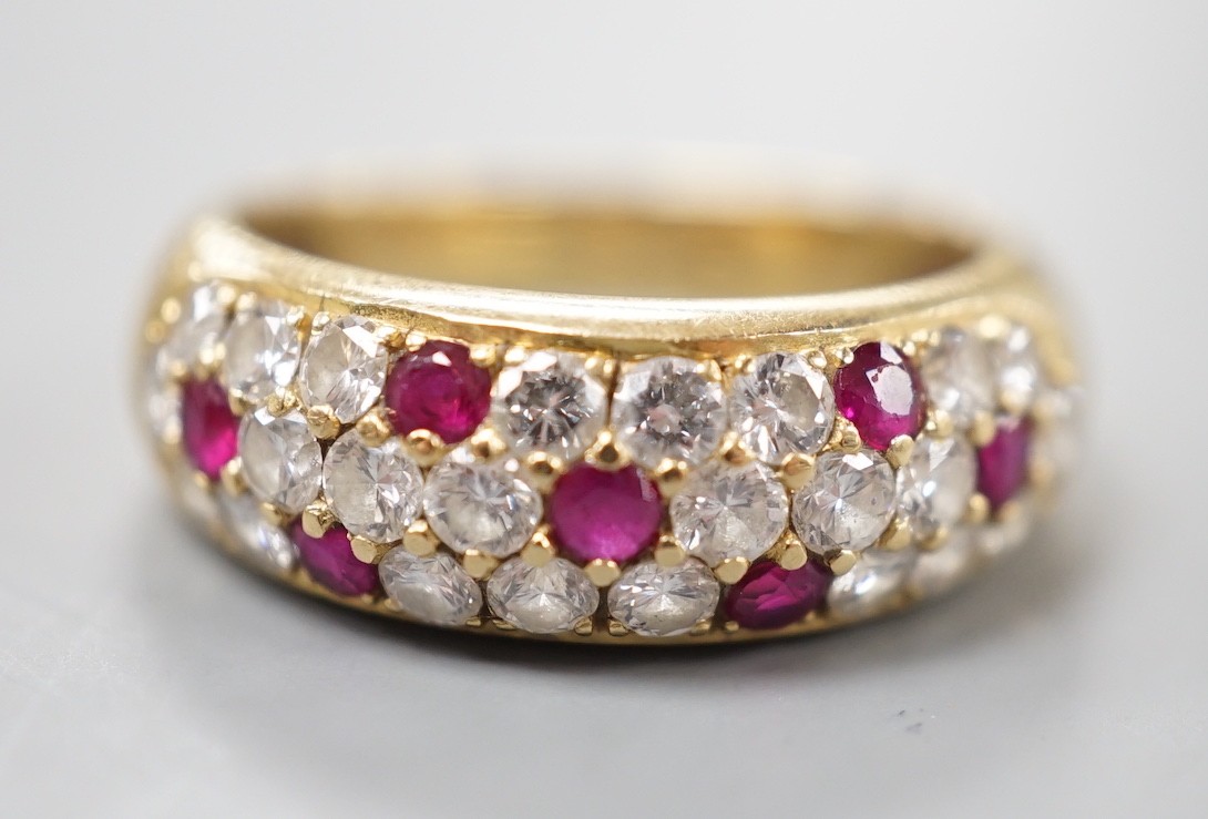 A modern yellow metal, ruby and diamond cluster set half hoop ring, size L/M, gross weight 4.5 grams.
